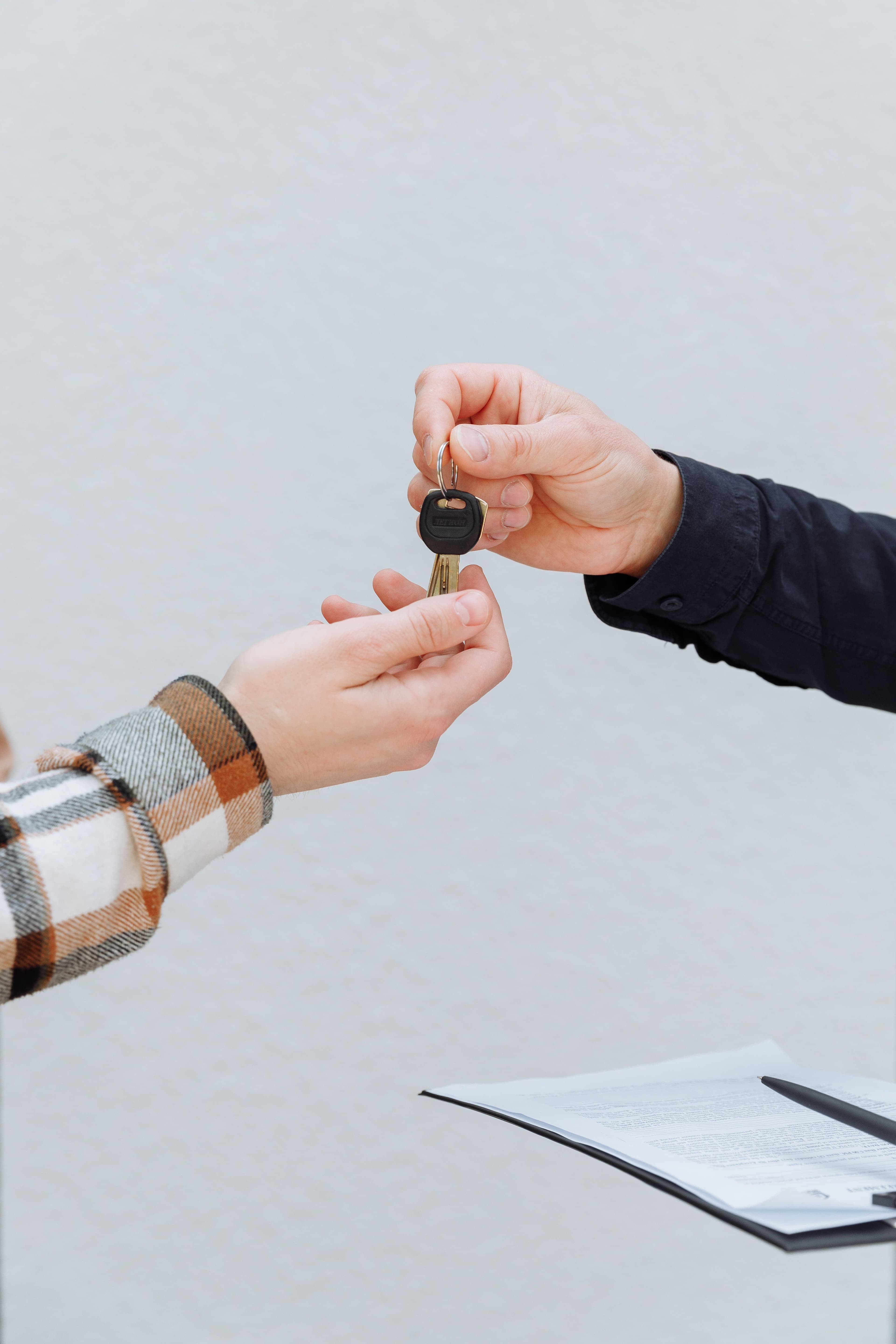 Close-up of hands exchanging car keys