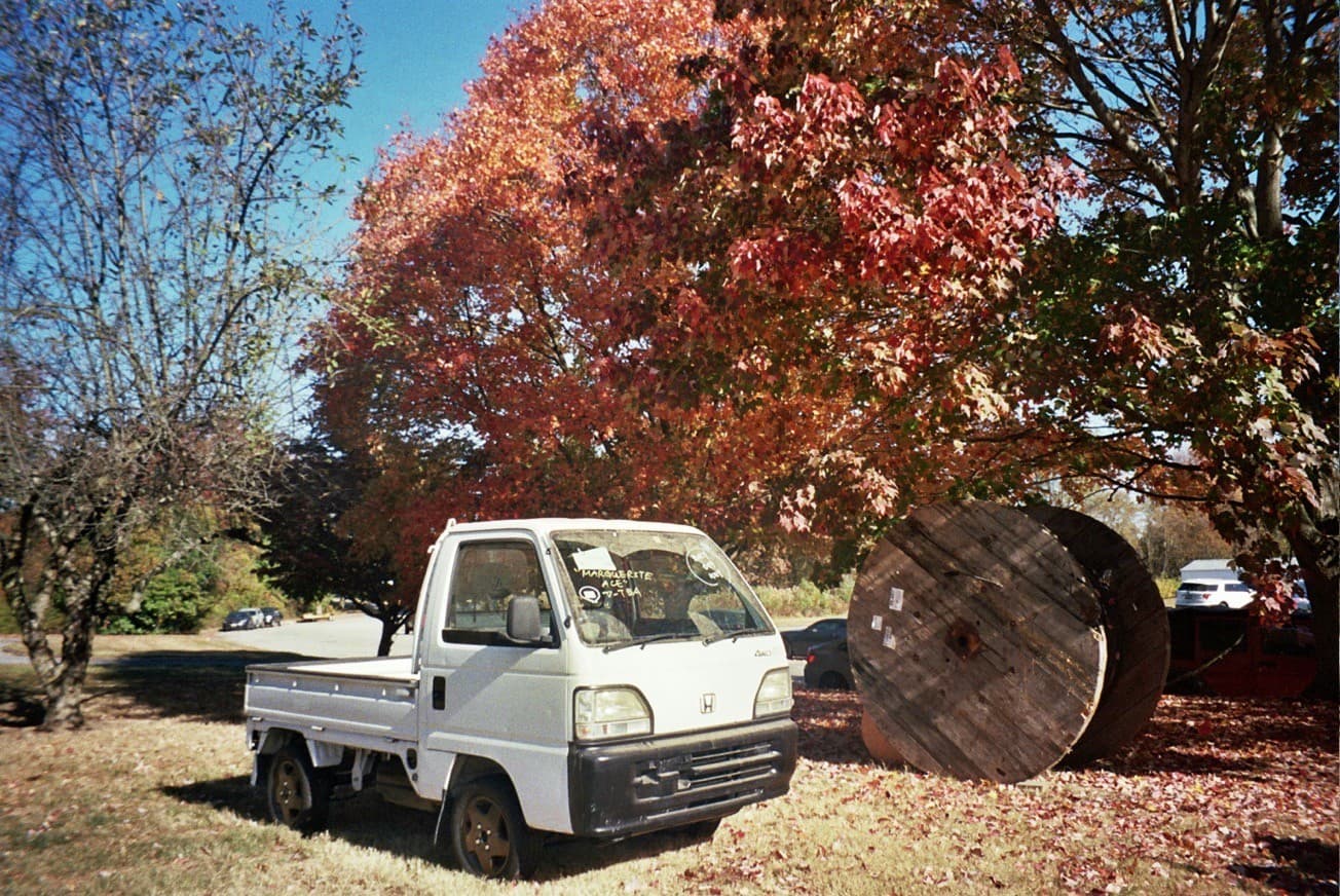The Simply Floatin Acty truck parked under fall foliage